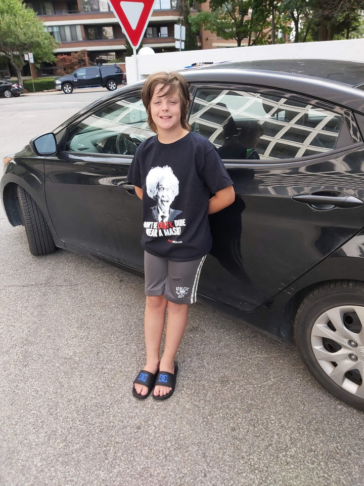 Boy wearing t-shirt with Einstein picture on it.on 